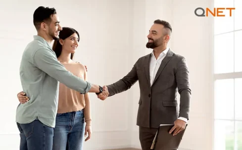 man and woman shake hands with man in suit