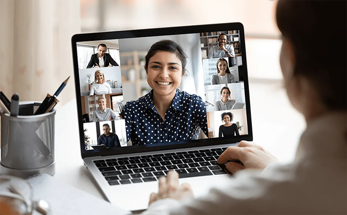 a young woman talking with her sales team on a laptop