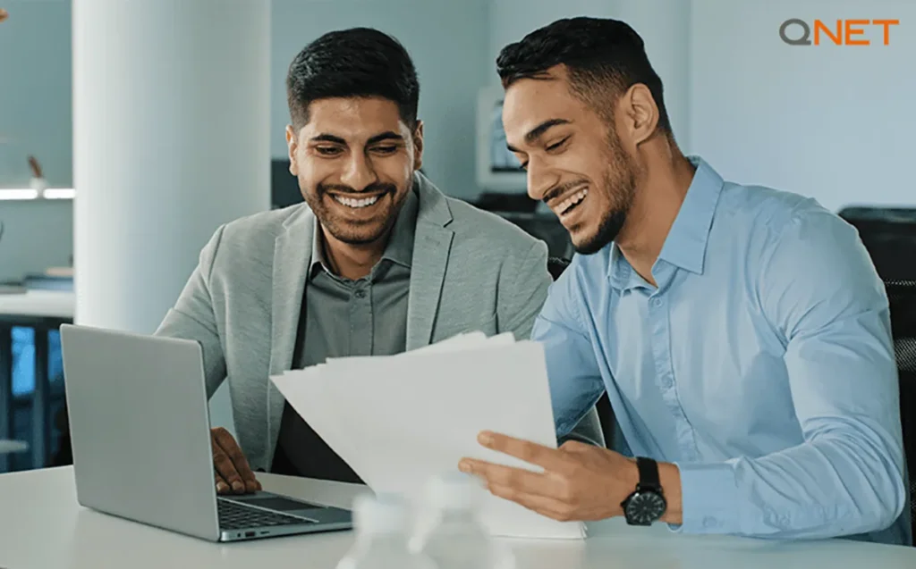 Young businessmen reading QNET’s Policies and Procedures to understand the opportunity and reject the QNET scam allegations