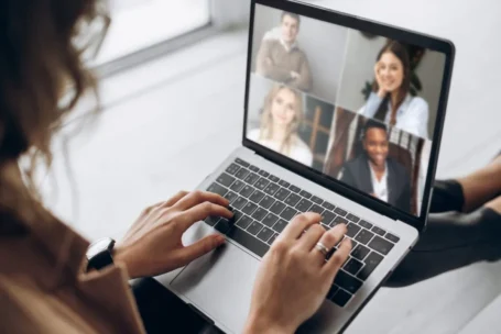Woman sitting at laptop calling meeting