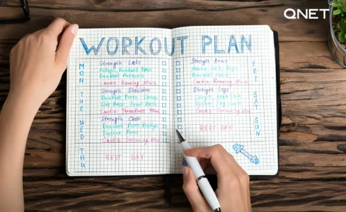 workout plan book being written on
