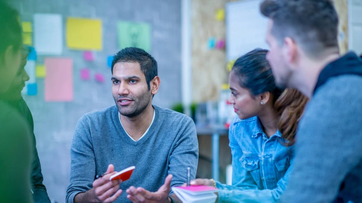 a man explains a subject to other people